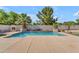 A backyard swimming pool surrounded by artificial turf and desert landscaping, with an outdoor fireplace feature at 3806 E Taurus Pl, Chandler, AZ 85249