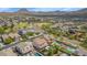 Aerial view of a community with desert landscape, a park and playground, and residences, all nestled near scenic mountains at 3813 W Lapenna Dr, New River, AZ 85087