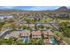 Scenic aerial view of a community featuring pools, well-manicured lawns, and charming homes under a vast blue sky at 3813 W Lapenna Dr, New River, AZ 85087