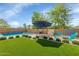 Lush backyard offers an inviting pool, charming seating, and a well-maintained lawn perfect for outdoor enjoyment at 3813 W Lapenna Dr, New River, AZ 85087
