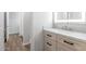 Bright bathroom with wood look floors, granite counters, a stylish light fixture, and a vanity cabinet at 3813 W Lapenna Dr, New River, AZ 85087