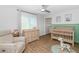 Bedroom with wood floors, neutral colors, stylish light fixture, a modern crib, and changing table at 3813 W Lapenna Dr, New River, AZ 85087