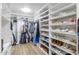 Large walk-in closet offers extensive shelving for shoes, clothing, and accessories at 3813 W Lapenna Dr, New River, AZ 85087