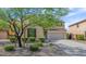 Two-story home featuring a neutral stucco, dark trim, a two car garage and a green lawn at 3813 W Lapenna Dr, New River, AZ 85087