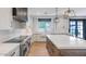 Bright kitchen with an island, stainless steel appliances, and backyard views from the sink at 3813 W Lapenna Dr, New River, AZ 85087