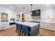 Modern kitchen with white cabinets, a large island with seating, and stainless steel appliances at 3813 W Lapenna Dr, New River, AZ 85087