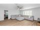 Neutral living room features a ceiling fan, large windows, and a sectional sofa at 3813 W Lapenna Dr, New River, AZ 85087