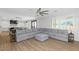 Bright, open concept living area features large sectional couch, kitchen and dining area at 3813 W Lapenna Dr, New River, AZ 85087