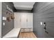Mud room includes gray shiplap, custom cabinets and hooks for storage at 3813 W Lapenna Dr, New River, AZ 85087