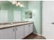 Well-lit bathroom featuring double sinks, granite countertops, and large mirror at 385 E Ironwood Dr, Chandler, AZ 85225