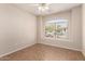 Empty bedroom featuring a large window with blinds and neutral-colored walls at 385 E Ironwood Dr, Chandler, AZ 85225