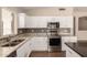 Updated kitchen with stainless steel appliances, granite countertops, and ample cabinet space at 385 E Ironwood Dr, Chandler, AZ 85225