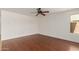 Clean and empty bedroom featuring hard wood floors, large windows, and neutral paint at 3929 W Goldmine Mountain Dr, San Tan Valley, AZ 85144
