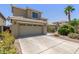 Two-story home with a two car garage, tile roof, and desert landscaping at 3929 W Goldmine Mountain Dr, San Tan Valley, AZ 85144