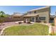 Home's backyard featuring lush lawn and pergola with seating, ideal for outdoor living at 3929 W Goldmine Mountain Dr, San Tan Valley, AZ 85144