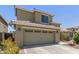 Two-story home with a two car garage, tile roof, and desert landscaping at 3929 W Goldmine Mountain Dr, San Tan Valley, AZ 85144