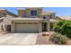 Two-story home with a two car garage, tile roof, and landscaped front yard at 3929 W Goldmine Mountain Dr, San Tan Valley, AZ 85144