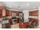 This kitchen offers stainless steel appliances, granite countertops, and a central island with bar stool seating at 3929 W Goldmine Mountain Dr, San Tan Valley, AZ 85144
