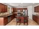 A nicely appointed kitchen featuring stainless steel appliances, granite countertops, and a central island with seating at 3929 W Goldmine Mountain Dr, San Tan Valley, AZ 85144
