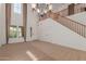 Open concept living room with high ceilings, staircase, and carpet flooring at 3929 W Goldmine Mountain Dr, San Tan Valley, AZ 85144