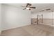 Bright loft featuring neutral carpeting, ceiling fan, and decorative wood and white banister at 3929 W Goldmine Mountain Dr, San Tan Valley, AZ 85144