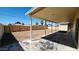 Covered patio overlooking a spacious backyard with fresh dirt and a wooden fence at 4219 W Citrus Way, Phoenix, AZ 85019