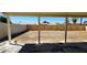View of large backyard with fresh dirt, wooden fence and covered patio in the distance at 4219 W Citrus Way, Phoenix, AZ 85019