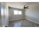Bedroom featuring a ceiling fan and window overlooking the green landscape outside at 4219 W Citrus Way, Phoenix, AZ 85019