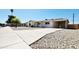 Inviting single story home featuring an attached carport, an inviting front porch, and rock landscaping at 4219 W Citrus Way, Phoenix, AZ 85019