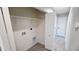 Laundry room with hookups, access to closet, and an additional entrance to the property at 4219 W Citrus Way, Phoenix, AZ 85019