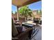 Relaxing covered patio with wicker furniture and a hot tub in the landscaped backyard at 4322 E Cottonwood Ln, Phoenix, AZ 85048