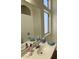 Bright bathroom featuring a white sink, vanity with soaps, and a large window at 4322 E Cottonwood Ln, Phoenix, AZ 85048