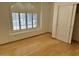 An empty bedroom with a closet, hardwood floors, and a window at 4322 E Cottonwood Ln, Phoenix, AZ 85048