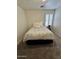 Carpeted bedroom with neutral decor and a window with white shutters at 4322 E Cottonwood Ln, Phoenix, AZ 85048