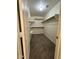 Spacious walk-in closet with neutral carpeting and plenty of shelving for optimal organization at 4322 E Cottonwood Ln, Phoenix, AZ 85048
