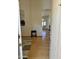Inviting foyer with wood floors, view to living space and a glimpse of natural light at 4322 E Cottonwood Ln, Phoenix, AZ 85048