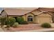 Charming single-story home featuring a well-maintained yard with desert landscaping and a two-car garage at 4322 E Cottonwood Ln, Phoenix, AZ 85048