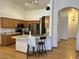 Bright kitchen featuring stainless steel refrigerator, oak cabinets, and island at 4322 E Cottonwood Ln, Phoenix, AZ 85048