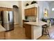 Kitchen featuring stainless steel refrigerator, oak cabinets, and center island at 4322 E Cottonwood Ln, Phoenix, AZ 85048
