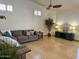 Bright living room with wood floors, neutral tones, comfortable seating, and large windows that provides natural light at 4322 E Cottonwood Ln, Phoenix, AZ 85048