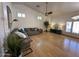 A well-lit living room featuring wood flooring, comfortable seating, and large windows for natural light at 4322 E Cottonwood Ln, Phoenix, AZ 85048