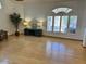 Spacious living room with bamboo floors, plantation shutters, and neutral tones, bathed in natural light at 4322 E Cottonwood Ln, Phoenix, AZ 85048