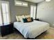 Serene main bedroom boasts natural light from shuttered windows, neutral colors, and dark wood furniture at 4322 E Cottonwood Ln, Phoenix, AZ 85048