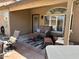Inviting covered patio with comfortable seating, a table, and outdoor decor at 4322 E Cottonwood Ln, Phoenix, AZ 85048