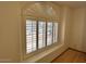 Window with arching shutters that bring ample light to the room at 4322 E Cottonwood Ln, Phoenix, AZ 85048