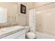 Traditional bathroom featuring white cabinets, tile countertops, and shower-tub combo at 4565 N Point Ridge Rd, Buckeye, AZ 85396