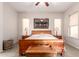 Comfortable bedroom with neutral walls, ceiling fan, and a decorative art piece over the bed at 4565 N Point Ridge Rd, Buckeye, AZ 85396