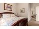 Bright bedroom features wood frame bed with floral bedding and light walls at 4565 N Point Ridge Rd, Buckeye, AZ 85396