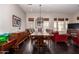 Elegant dining room features a large wooden table, hardwood floors, and a stylish chandelier at 4565 N Point Ridge Rd, Buckeye, AZ 85396