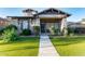 Charming single-story home featuring stone accents, a well-manicured lawn, and a welcoming front porch at 4565 N Point Ridge Rd, Buckeye, AZ 85396
